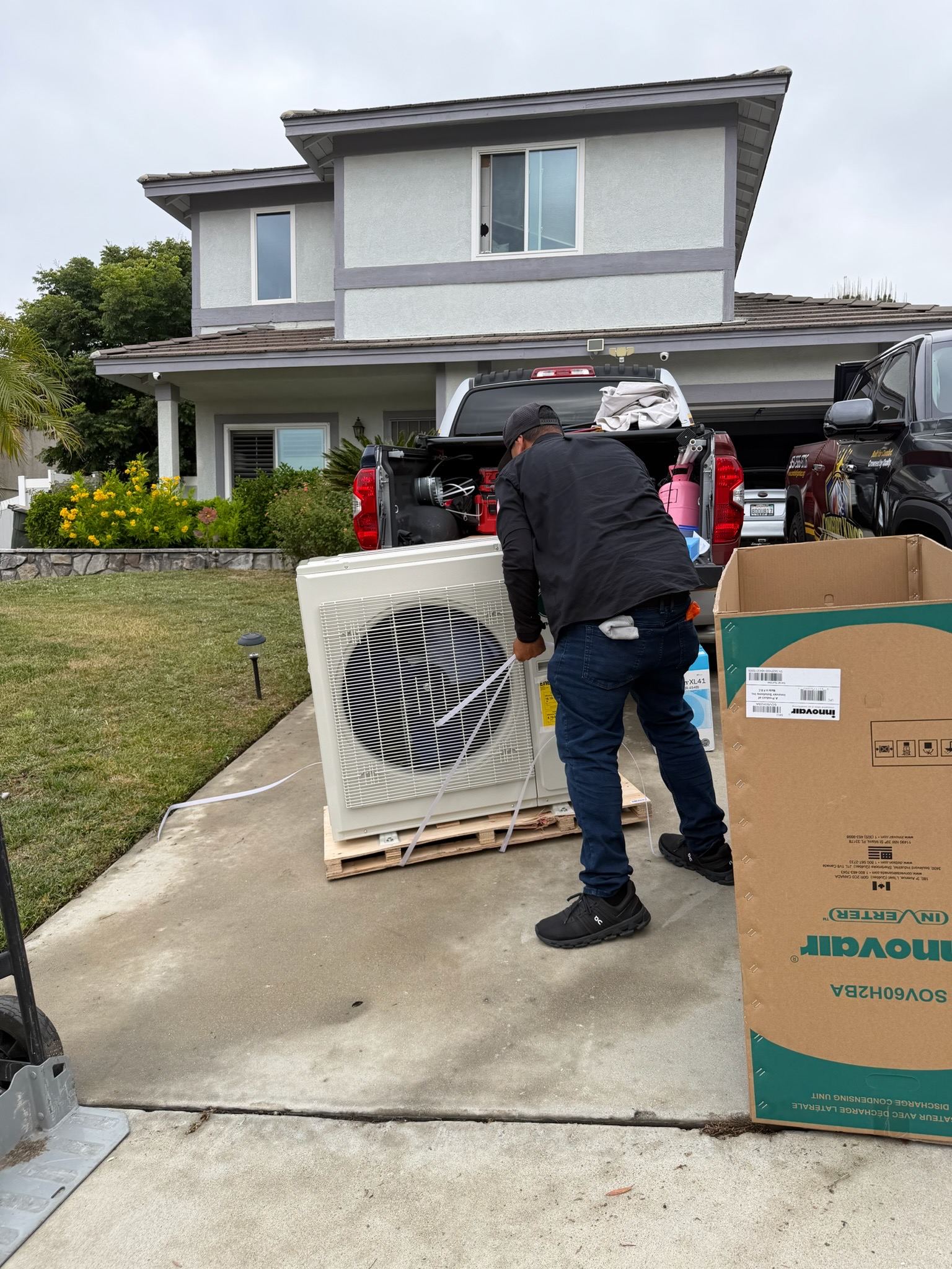 Technician unboxing a new mini-split condenser