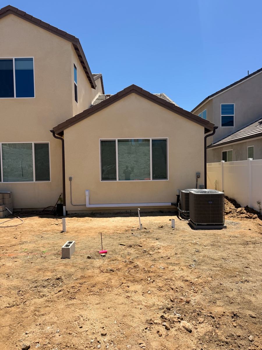 Two relocated condensers beside an Oceanside home