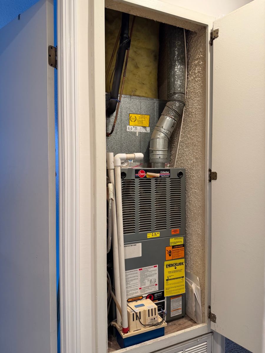 Old furnace in a closet before replacement in Poway