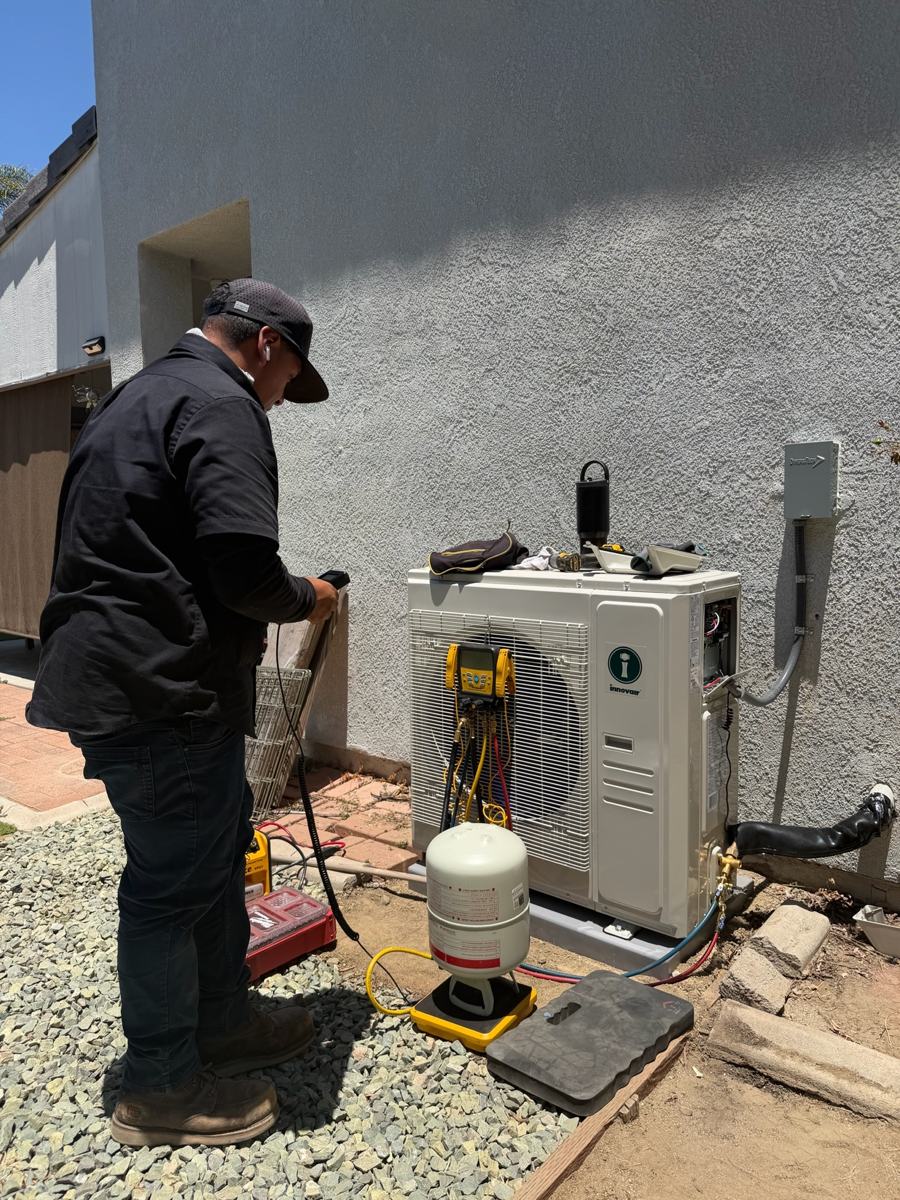 Technician installing a mini-split outdoor unit