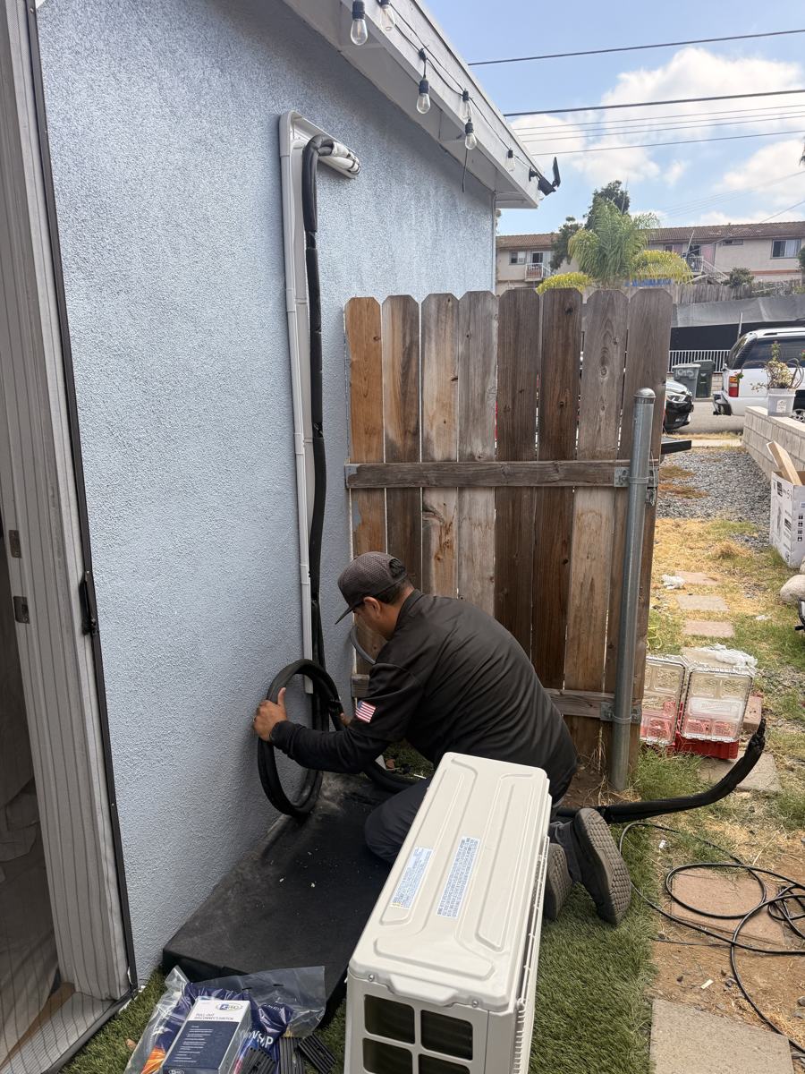 Technician installing a mini-split condenser in Vista